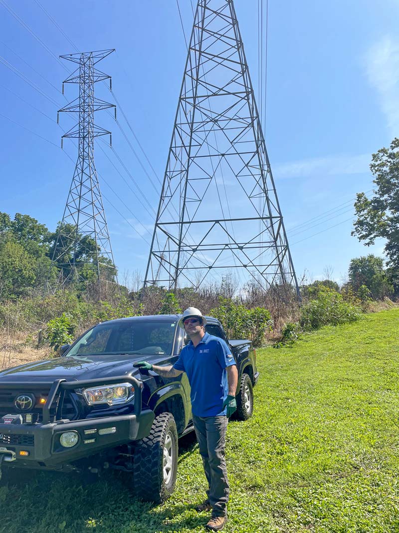 TVA right-of-way forester Matt Townsend looks up at a transmission tower