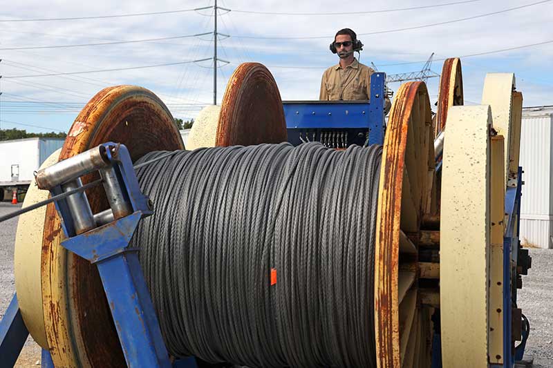 A machine rolls up the tested rope.