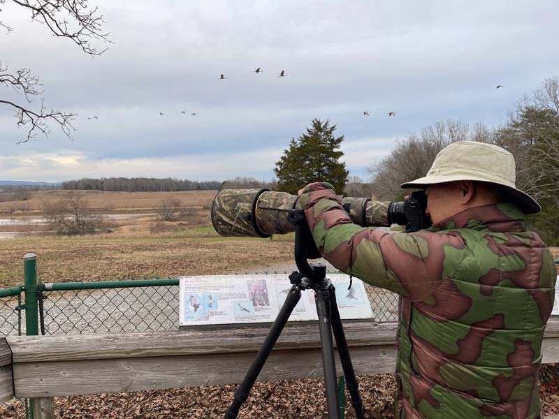 A photographer uses a telephoto lens to zoom in on wildlife at Hiwassee Wildlife Refuge in Birchwood, Tennessee