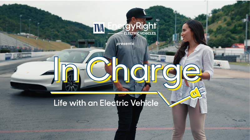 People charging electric vehicle