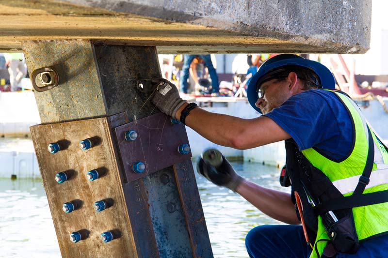 Industrial Worker screwing in bolt