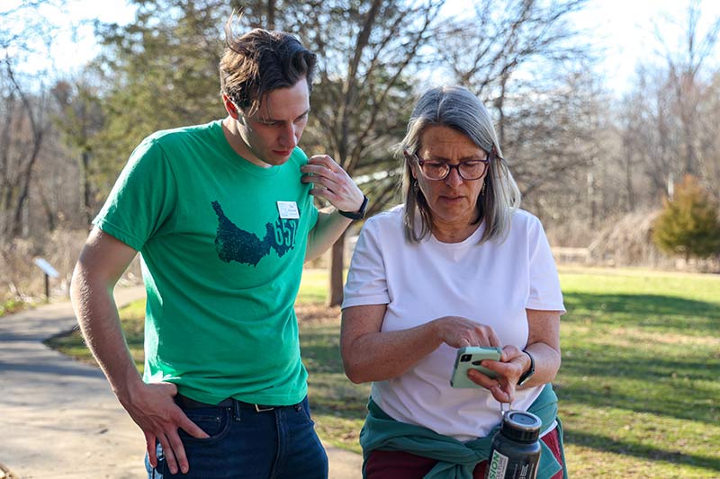 Nature program participants view a smartphone app