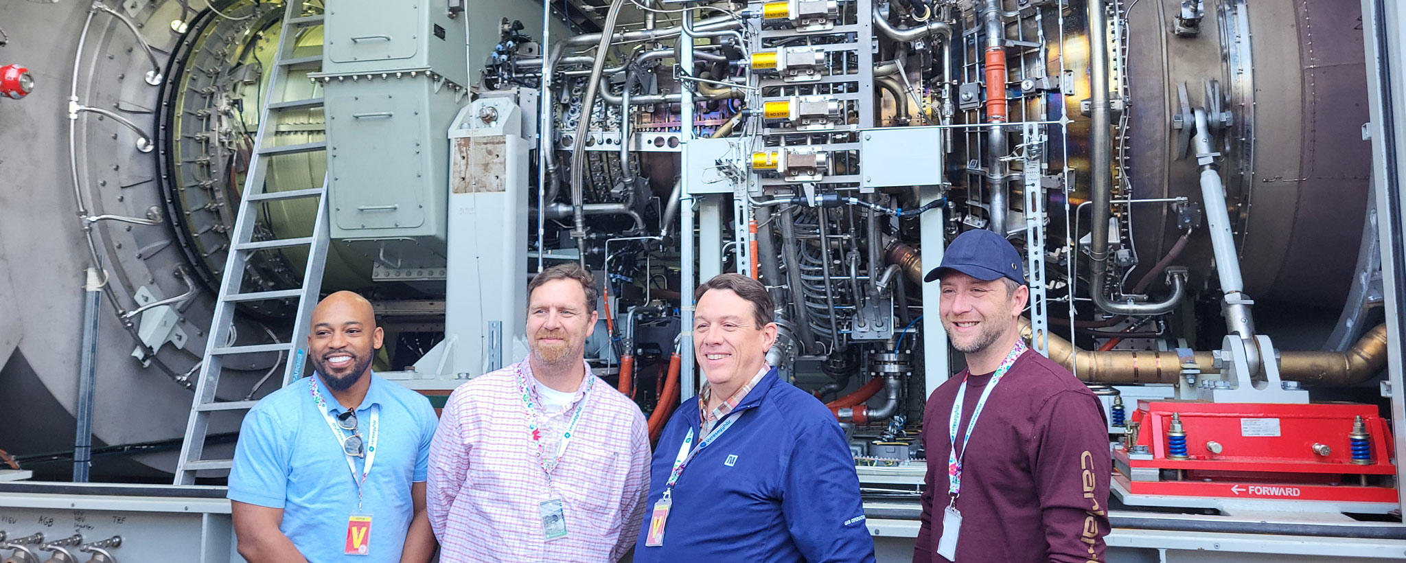 Johnsonville generator TVA team members stand next to a new aeroderivative gas turbine destined for a TVA site in New Johnsonville, Tennessee