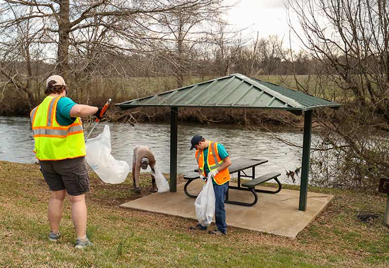 Volunteers picking up trash at picnic areas