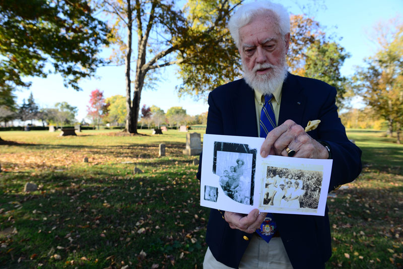 Kenneth Thomson Jr. holds photos of people who had lived at Odom’s Bend.