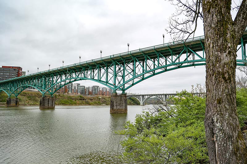 A Knoxville bridge viewed from a shoreline perspective