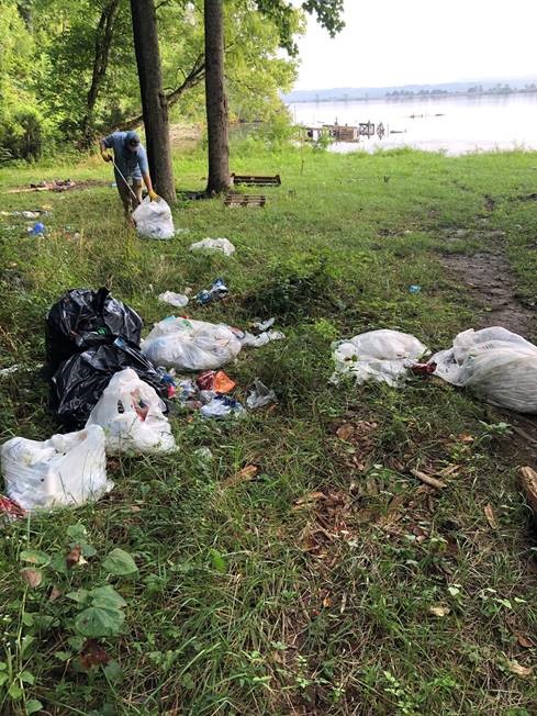 Man picking up the trash in a camp ground