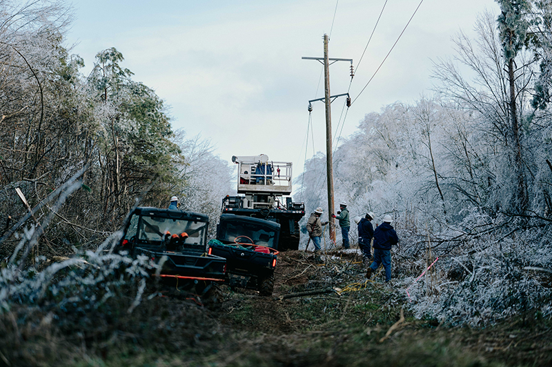 LIneworkers with ATVs and heavy equipment work on transmission lines in Mississippi following Winter Storm Fern