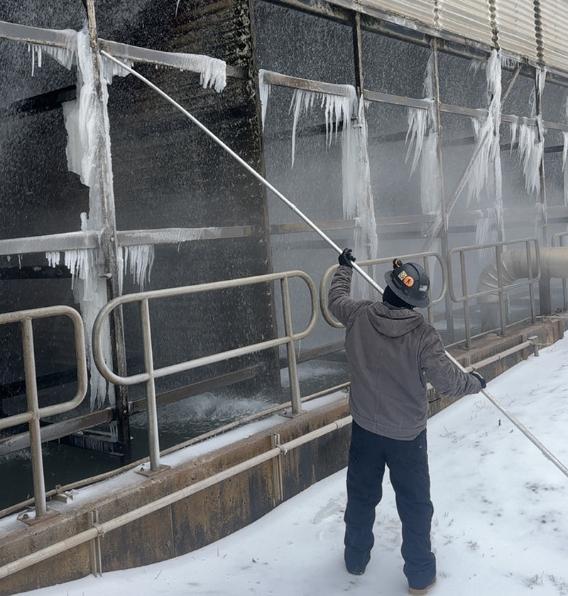 A crew member battles the ice at Magnolia Combined Cycle Plant.