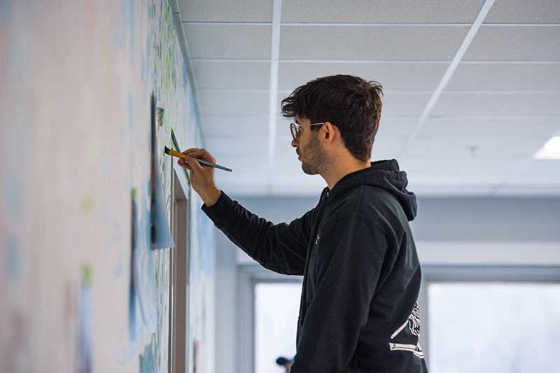 Person painting mural. It used a 