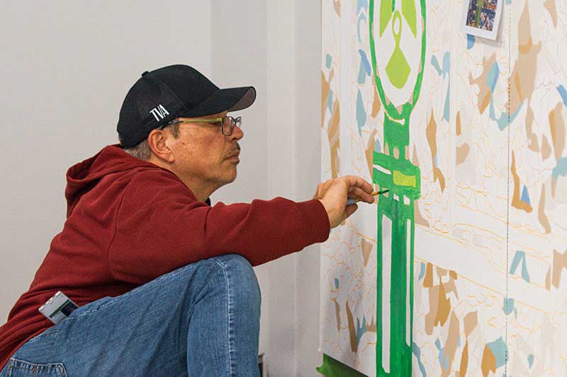 TVA employee working on mural at Raccoon Mountain