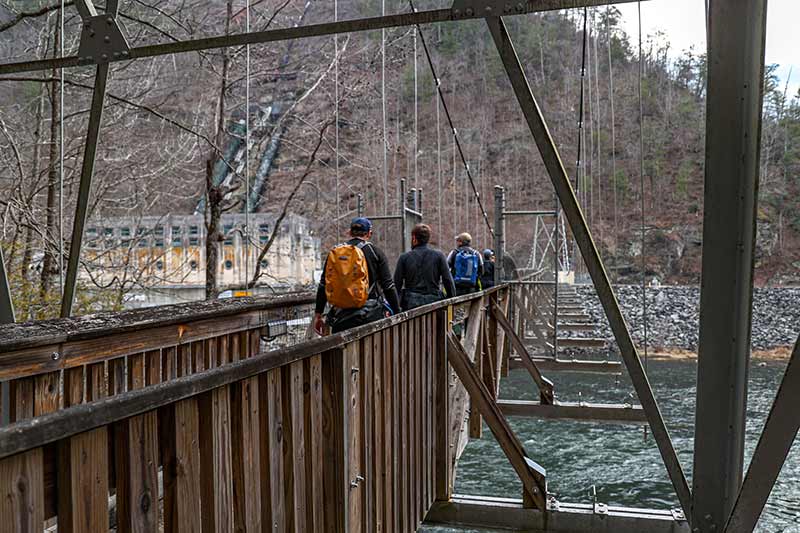 Four people walking across a bridge at Apalachia Dam Powerhouse