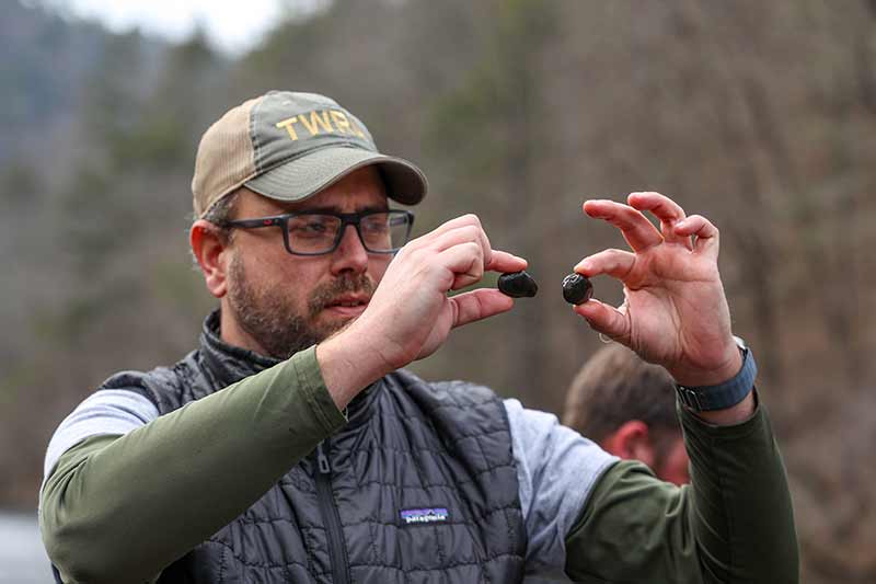 TWRA biologist Tim Lane holds up mussels
