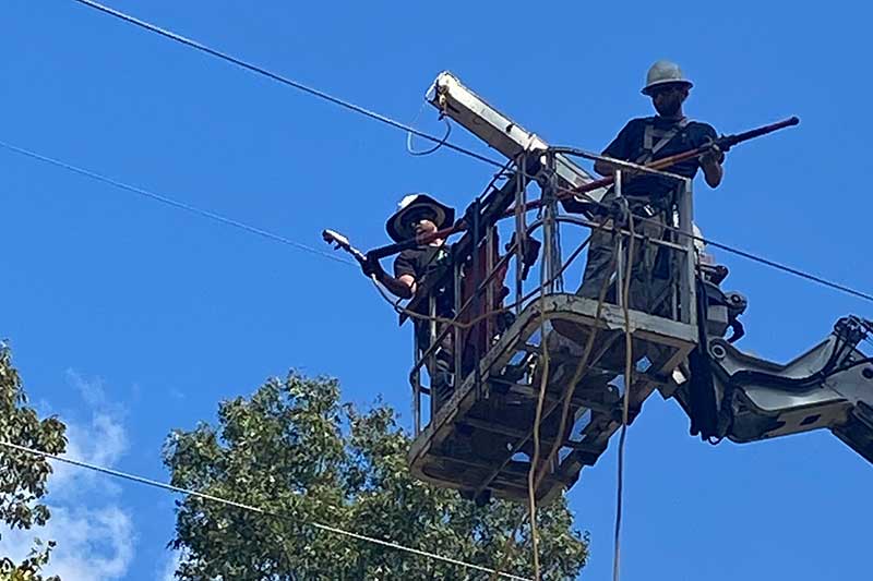 Lineworkers in bucket lift.