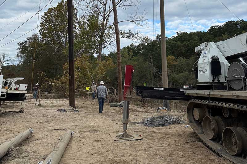 Lineworkers repairing damaged power poles.