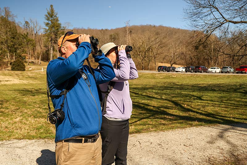 Norris Reservoir birdwatchers peer through binoculars