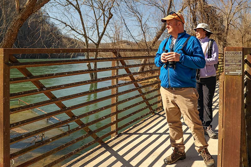 Two Norris Reservoir visitors cross a bridge while birdwatching