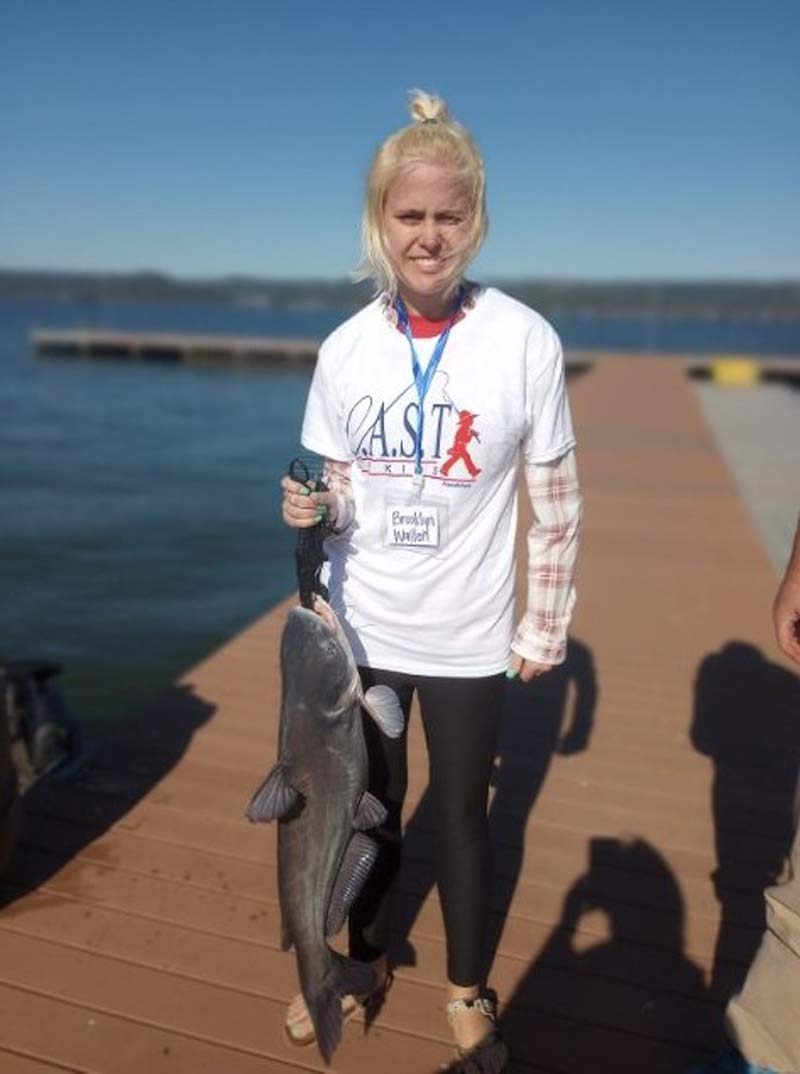 Participant Brooklyn Wallen holds her catch of the day: a 13-pound catfish. 