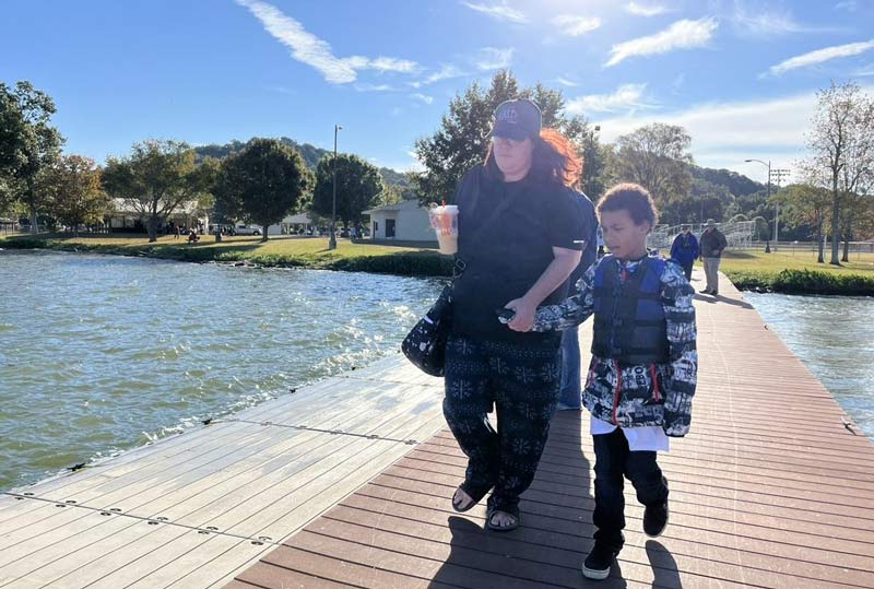 Participant James Glover walks down the pier to begin his fishing adventure.  