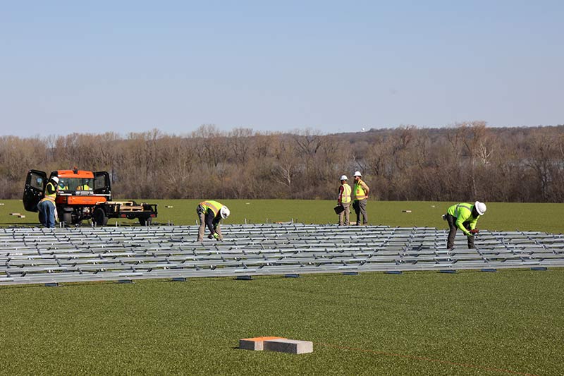Workers install equipment at the Project Phoenix site