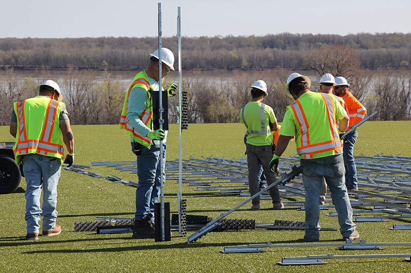 Six crew members mapping placement of racks at Project Phoenix site