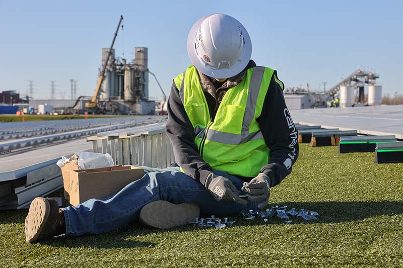 Crew member installs hardware at Project Phoenix site