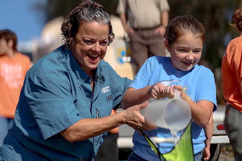 Releasing sturgeon into the water at Sturgeonfest