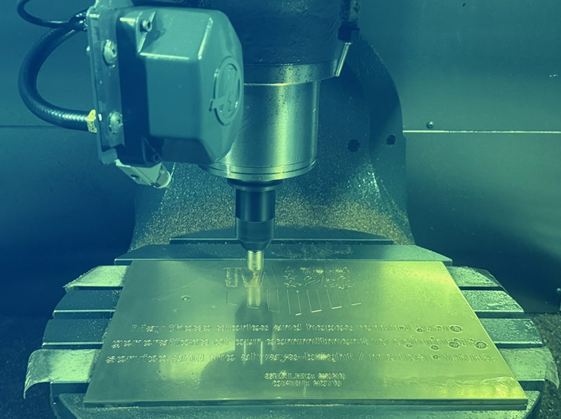 A CNC mill engraves the time capsule nameplate.