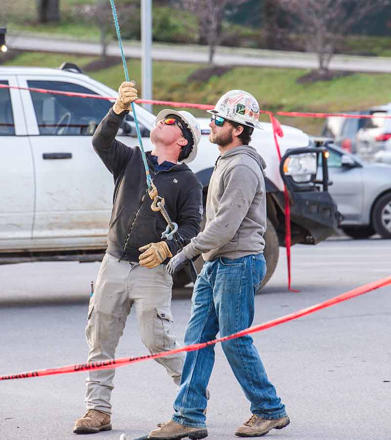 Lineworkers working on ground.