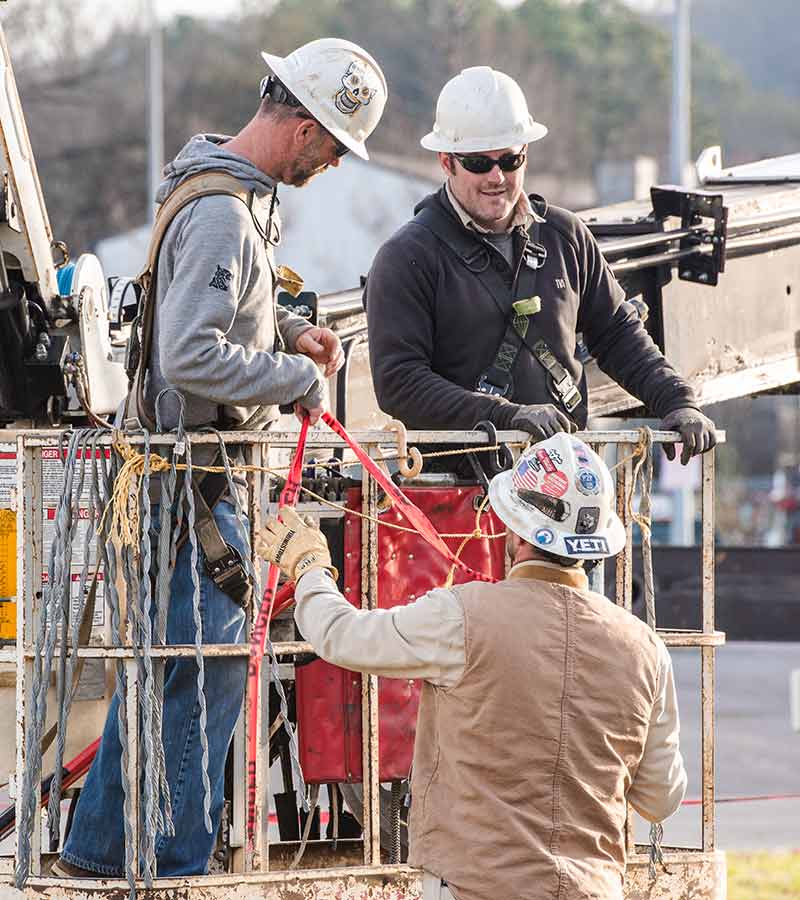 Lineworkers standing in lift.