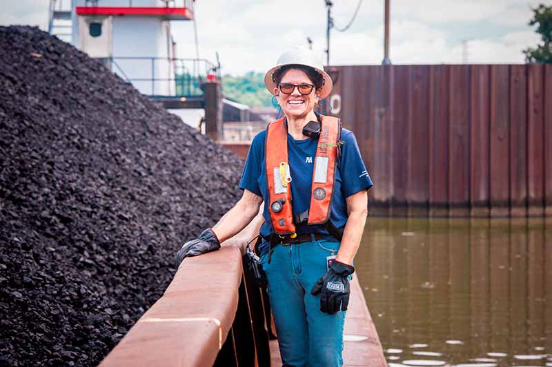 Kristy Collins stands next to a load of coal at Gallatin Fossil Plant.