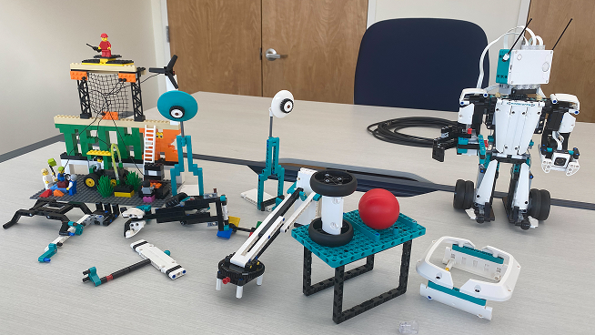 A table showcasing a collection of various robotics projects, featuring different designs and components.
