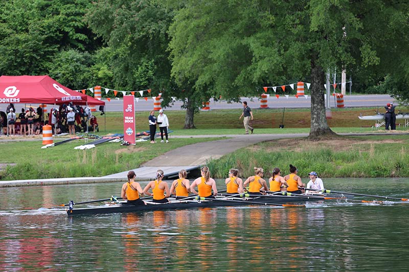 SEC team rowing near shoreline at Melton Hill Reservoir