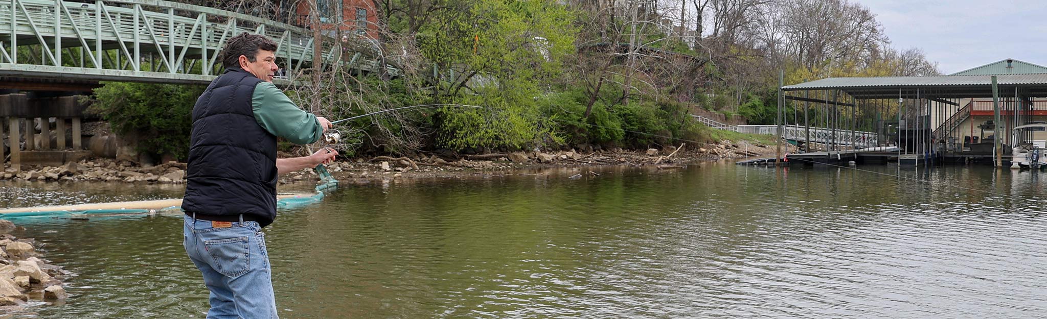 Silver Chub hero crop Bo Baxter fishing from shoreline in downtown Knoxville