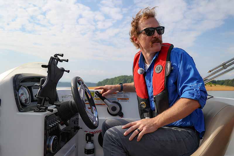 Lyn Williams, TVA Fisheries and Aquatic Monitoring manager, pilots a boat to a sampling site.