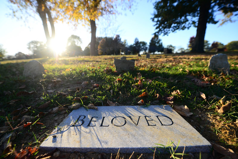 A stone tablet bearing the word “Beloved” marks a gravesite at the Garden of Eternal Freedom.  