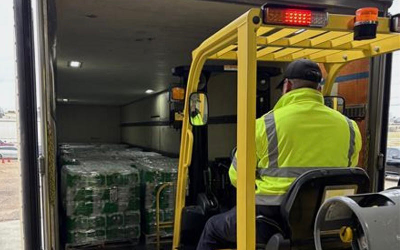 A member of TVA Supply Chain manages bottled water for distribution during severe weather.