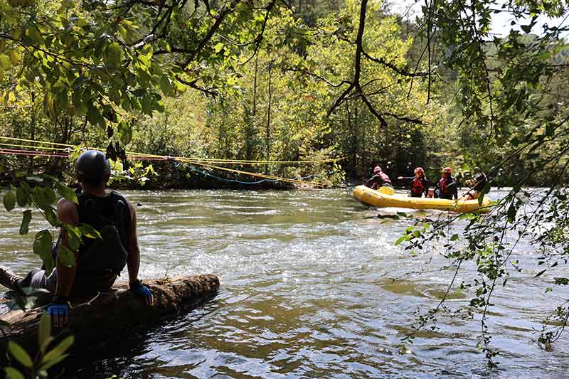 Team in raft during swift-water rescue training exercise