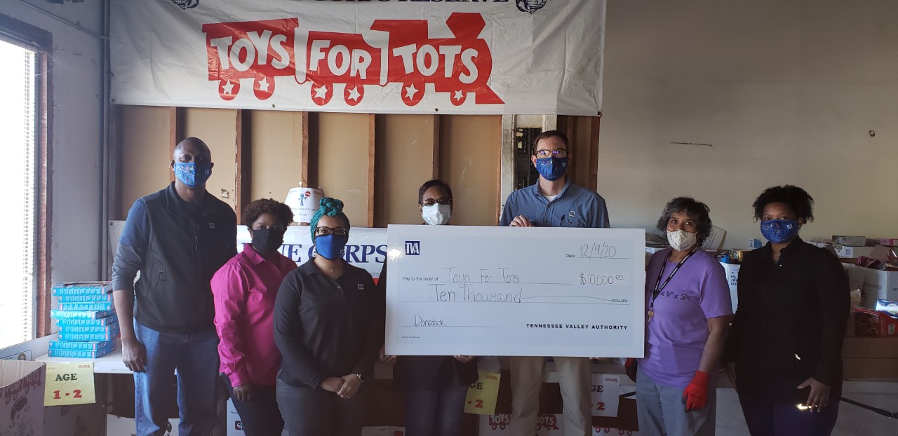 memphis employees check presentation for Toys for Tots