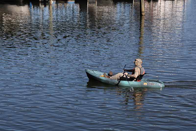 Kayaker on Tennessee River looking for litter