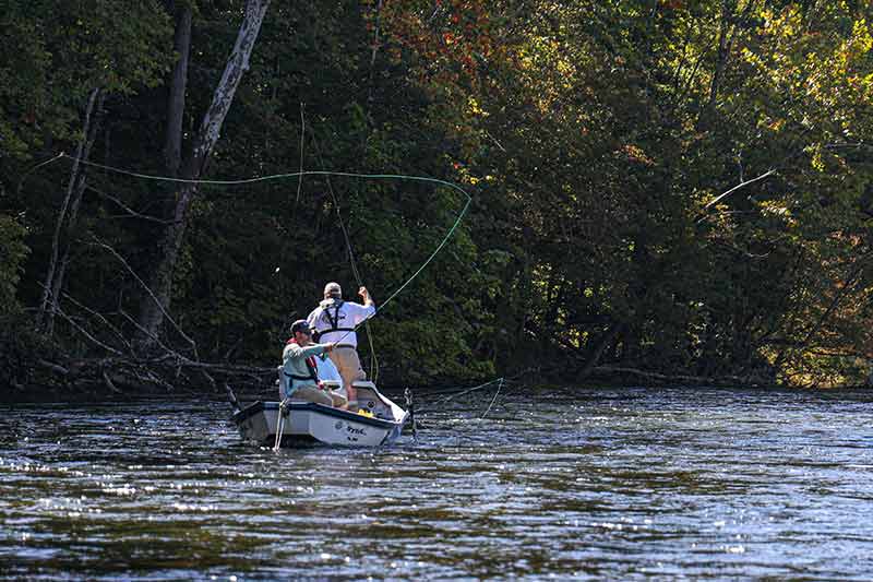 Anglers casting from boat.