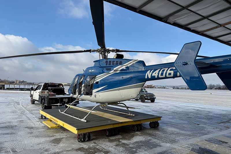 TVA helicopter towed from hangar to resume transmission line restoration work following Winter Storm Fern.