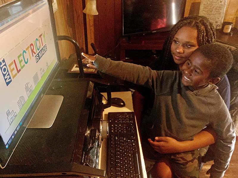 Mom and Son looking at tva kids on a computer