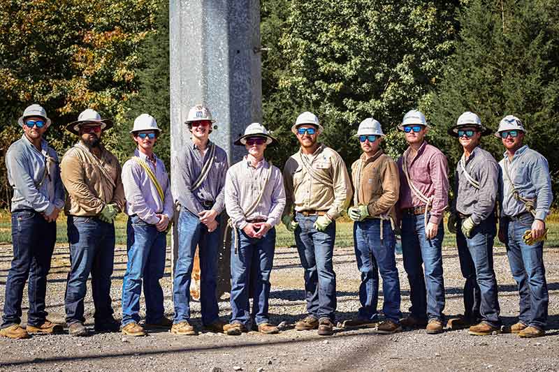 Graduates of the TVA lineworker apprentice climbing school