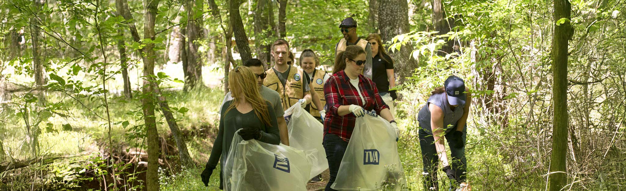 TVA volunteers cleaning up trash on trail