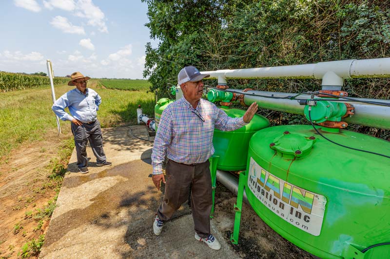 Two Bridgeforth farmers inspect irrigation equipment