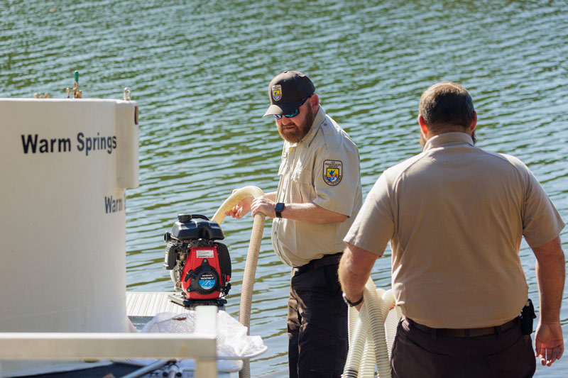 U.S. Fish and Wildlife Service team members release sturgeon into the French Broad River