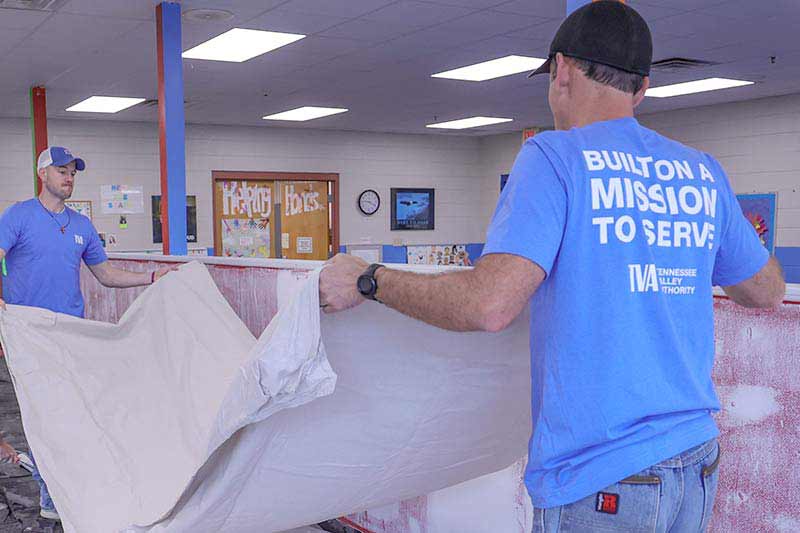 Volunteers with tarp