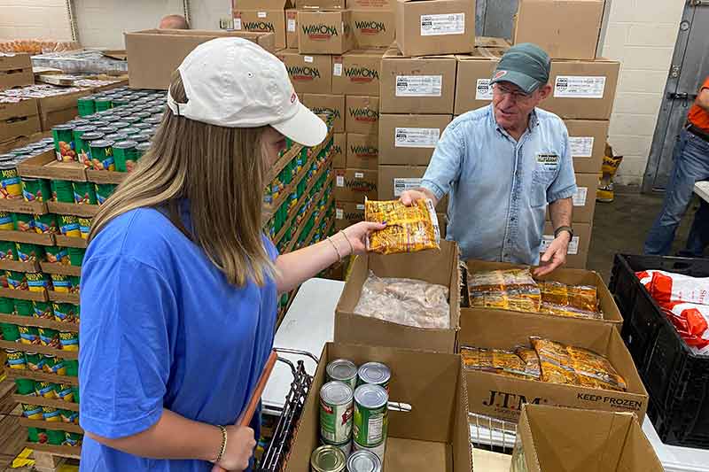 TVA employees help pack food boxes for distribution at food pantries across the region