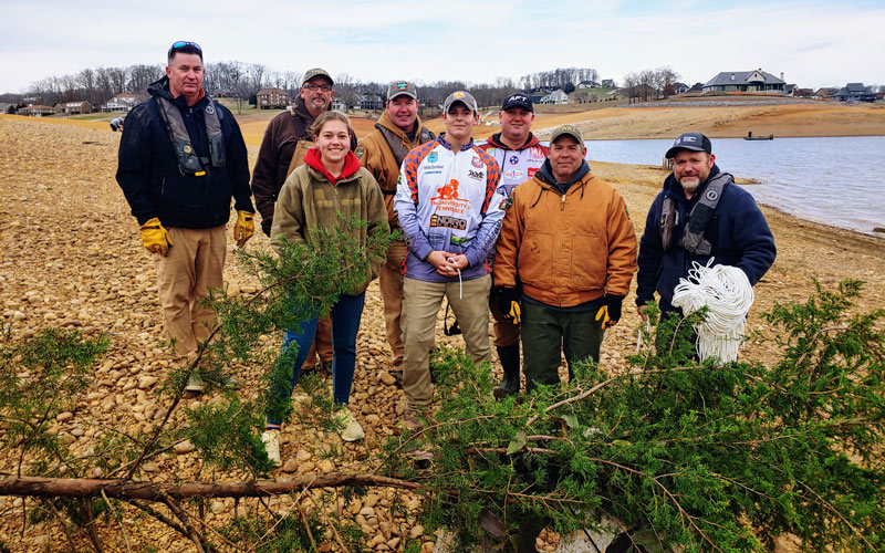 Volunteers ready to create fish habitats by submerging trees in lakes